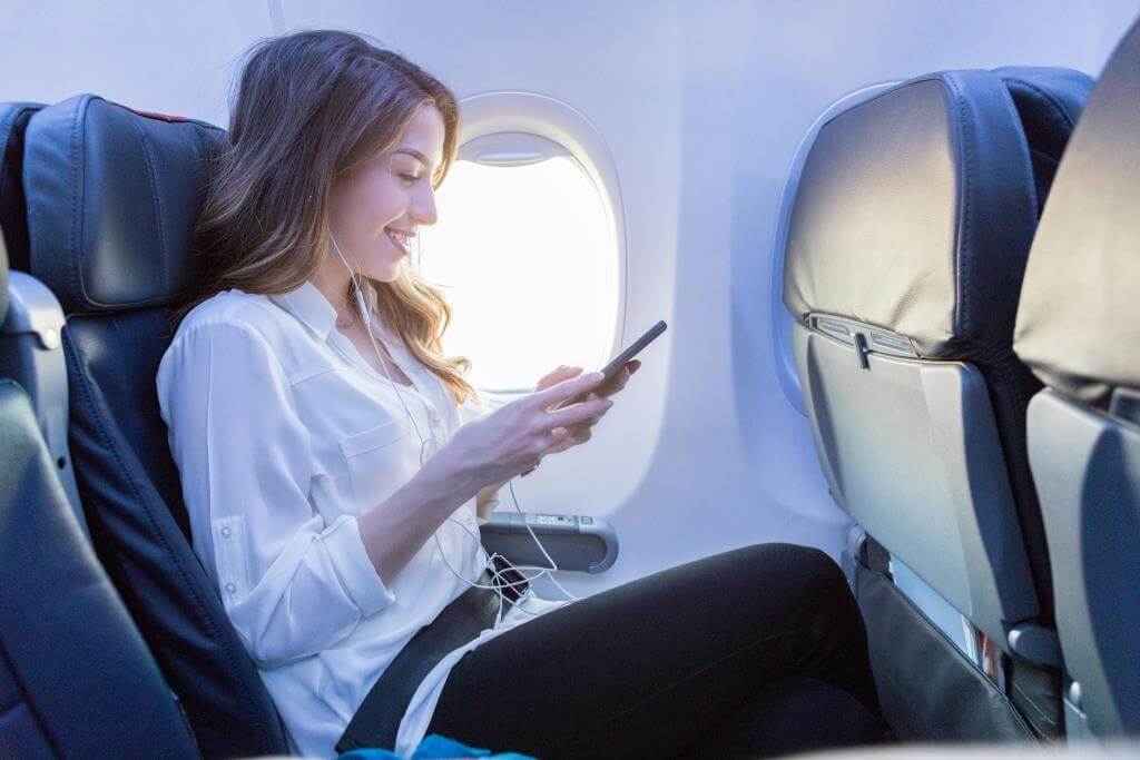 woman on phone in plane